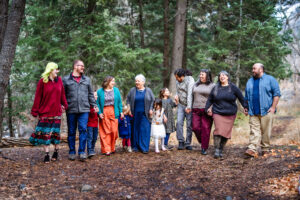 family photo of mom with kids and grandkids amongst pine trees in the mountains of Utah