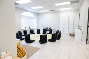 Moms join in a circle for weekly classes at New Mom School Encinitas that support their new motherhood journey