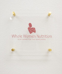 Logo outside of the lactation consultant's office at New Mom School Encinitas says "whole woman nutrition, nurturing for the nurturers."